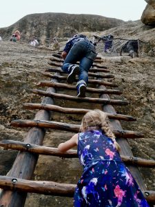 Climbing steep ladders on cliffs